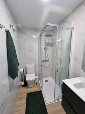 a bathroom with a shower and a toilet and a sink at Apartamento Playa Victoria I in Cádiz