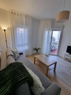 a living room with a couch and a table at Apartamento Playa Victoria I in Cádiz