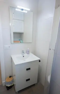 a bathroom with a white sink and a mirror at Chiclana.Balconera.1ªlínea playa in Chiclana de la Frontera