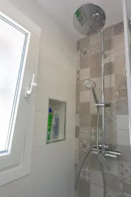 a shower with a shower head in a bathroom at Chiclana.Balconera.1ªlínea playa in Chiclana de la Frontera
