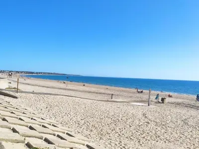 a beach with people and the ocean in the background at Chiclana.Balconera.1ªlínea playa in Chiclana de la Frontera