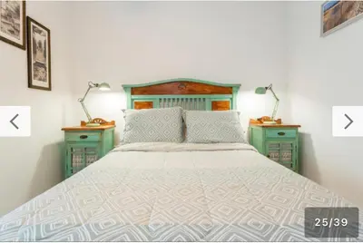 a bedroom with a large bed with two night stands at Apartamento con vistas al mar in Rota