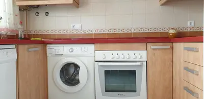 a small kitchen with a washing machine and a sink at Chiclana Costa in Chiclana de la Frontera
