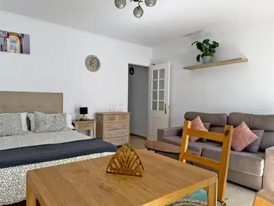 a small bedroom with a bed and a window at Apartamento Las Ninas - Ole Solutions in El Puerto de Santa María