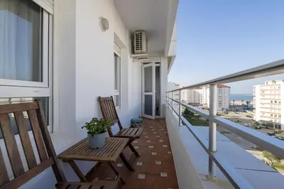 two chairs on a balcony with a view of the city at El Trebol in El Puerto de Santa María