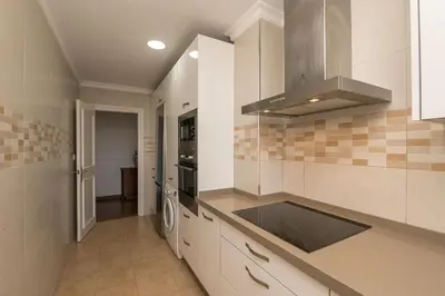 a kitchen with a sink and a stove top oven at El Trebol in El Puerto de Santa María