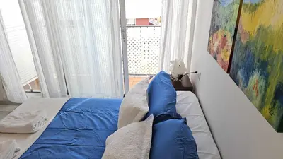 a bedroom with a bed and a painting on the wall at Infanta Isabel petfriendly by Sanlúcar Housing in Sanlúcar de Barrameda