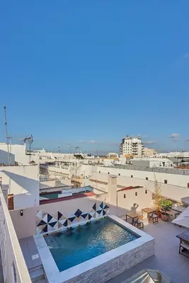 a lobby with palm trees and a counter at VG - Villa de Andas suites in Cádiz