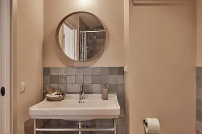 a bathroom with a sink and a mirror at VG - Villa de Andas suites in Cádiz