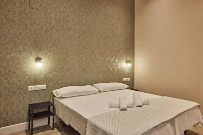 a bedroom with a bed with two towels on it at VG - Villa de Andas suites in Cádiz