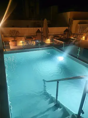 two glasses of wine and a book on a table at VG - Villa de Andas suites in Cádiz