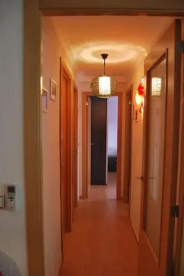a hallway in a house with a chandelier at Apartamento cerca del centro in Jerez de la Frontera