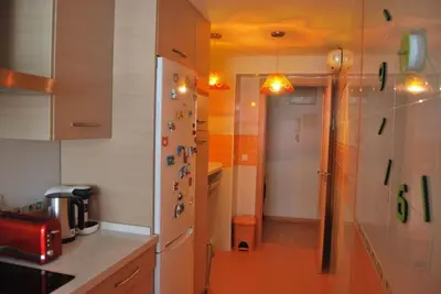 a kitchen with a counter and a hallway with a room at Apartamento cerca del centro in Jerez de la Frontera