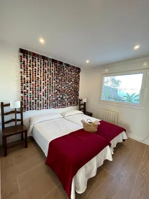 a bedroom with a large bed and a window at Santa Catalina primera línea de mar con vistas a Cádiz in El Puerto de Santa María