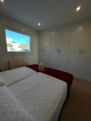 a bedroom with two beds and a window at Santa Catalina primera línea de mar con vistas a Cádiz in El Puerto de Santa María