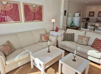 a living room with two couches and two tables at Santa Catalina primera línea de mar con vistas a Cádiz in El Puerto de Santa María