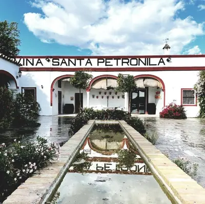 a building with a fountain in front of it at Viña Santa Petronila Torre in Jerez de la Frontera