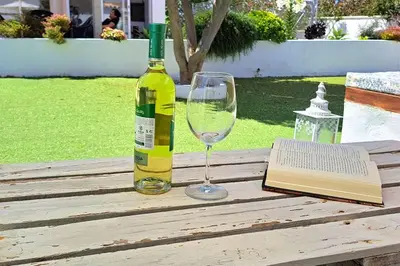 a bottle of wine and a glass on a table at Alojamiento Mise in Conil de la Frontera