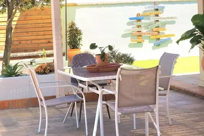 a white table and chairs on a patio at Alojamiento Mise in Conil de la Frontera
