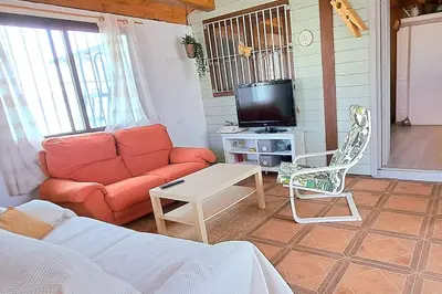 a living room with a couch and a tv at Alojamiento Mise in Conil de la Frontera