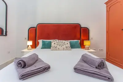 a bedroom with a large bed with two towels on it at Apartamento Centro con Parking Privado in El Puerto de Santa María