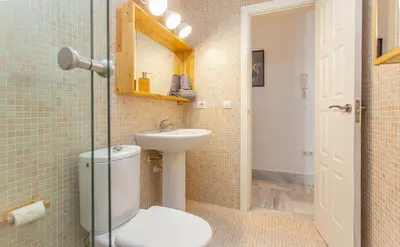 a bathroom with a toilet and a sink at Apartamento Centro con Parking Privado in El Puerto de Santa María