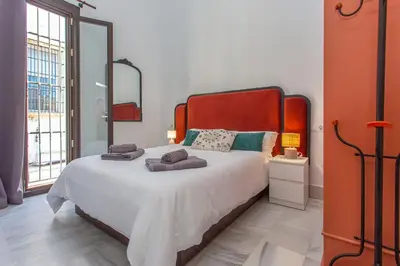 a bedroom with a large bed with towels on it at Apartamento Centro con Parking Privado in El Puerto de Santa María