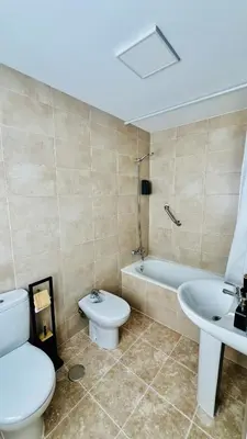 a bathroom with a toilet and a sink at Altos de Jerez & Parking Privado in Jerez de la Frontera