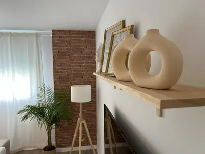 two vases sitting on a shelf in a living room at Jardines del Porvenir 4 in Puerto Real