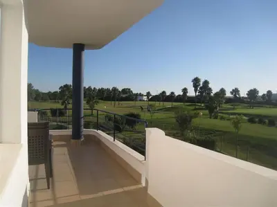 a balcony with a view of a golf course at Vacaciones de lujo GOLF-PLAYA. Costa Ballena-Cádiz in Rota