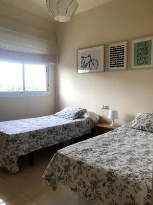 a bedroom with two beds and a window at Vacaciones de lujo GOLF-PLAYA. Costa Ballena-Cádiz in Rota