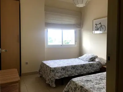 a bedroom with two beds and a window at Vacaciones de lujo GOLF-PLAYA. Costa Ballena-Cádiz in Rota