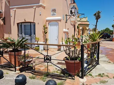 a wrought iron gate with potted plants in front of a building at Apartamento La Vasca in El Puerto de Santa María