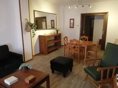 a living room with a table and chairs at ENTRE SAL Y ARENA in Cádiz