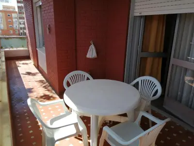 a white table and chairs on a balcony at ENTRE SAL Y ARENA in Cádiz