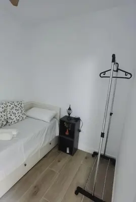 a bedroom with a bed and a tripod next to it at Fantástico piso nuevo, Mentidero in Cádiz