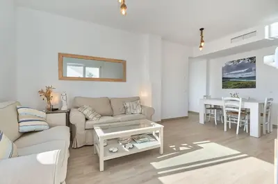 a living room with a couch and a table at Acogedora vivienda Costa Ballena in Chipiona
