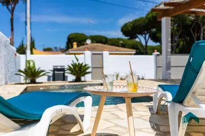 a table and chairs on a patio with drinks on it at VILLA SUR in Chiclana de la Frontera