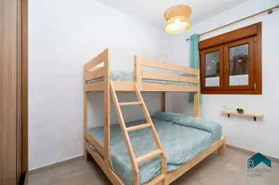 a bunk bed in a room with a ladder at VILLA SUR in Chiclana de la Frontera