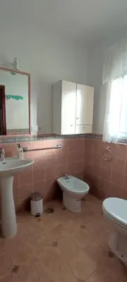 a bathroom with a toilet and a bidet and a sink at Beach house near Tennis Club La Barrosa in Chiclana de la Frontera