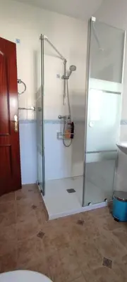 a bathroom with a shower with a glass door at Beach house near Tennis Club La Barrosa in Chiclana de la Frontera