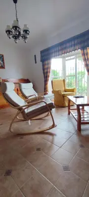a living room with two chairs and a table at Beach house near Tennis Club La Barrosa in Chiclana de la Frontera