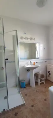 a white bathroom with a sink and a shower at Beach house near Tennis Club La Barrosa in Chiclana de la Frontera