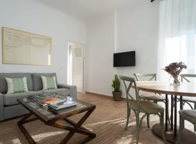 a living room with a couch and a table at Apartoyou - Río Guadalete in El Puerto de Santa María