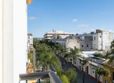 a view of a city with palm trees and buildings at Apartoyou - Río Guadalete in El Puerto de Santa María