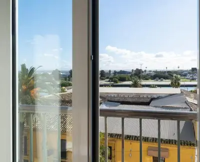 a view of a balcony with a view of a building at Apartoyou - Río Guadalete in El Puerto de Santa María