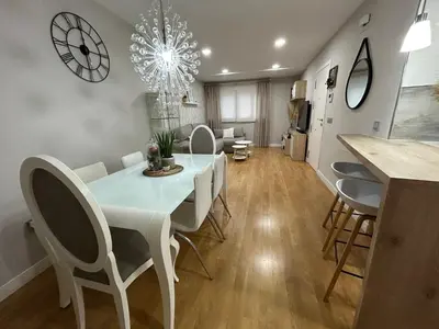 a dining room with a white table and chairs at Villa Malena in Chiclana de la Frontera