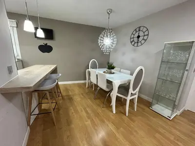 a dining room with a white table and chairs at Villa Malena in Chiclana de la Frontera
