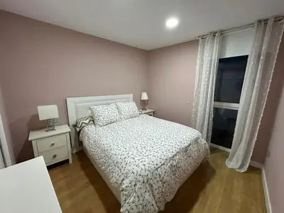 a small bedroom with a bed and a window at Villa Malena in Chiclana de la Frontera