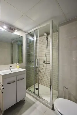 a bathroom with a shower and a toilet and a sink at Paso del Mar Ha Apartment in Cádiz